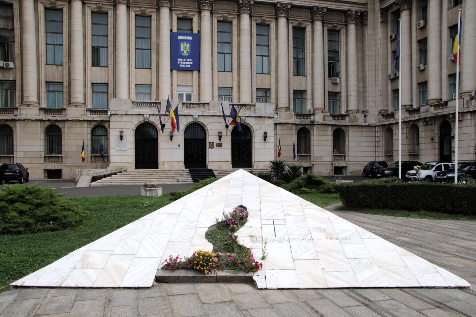 The building where Ceauşescu delivered his final speech.  The white pyramid now serves as a memorial, pointing upwards to the balcony where Nicolae Ceaușescu delivered his final address on 21st December 1989.  The pyramid is inscribed “Glorie martirilor nostril”, which means “Glory to our martyrs” as a memorial to the 49 people killed and 500 wounded there on that day. 