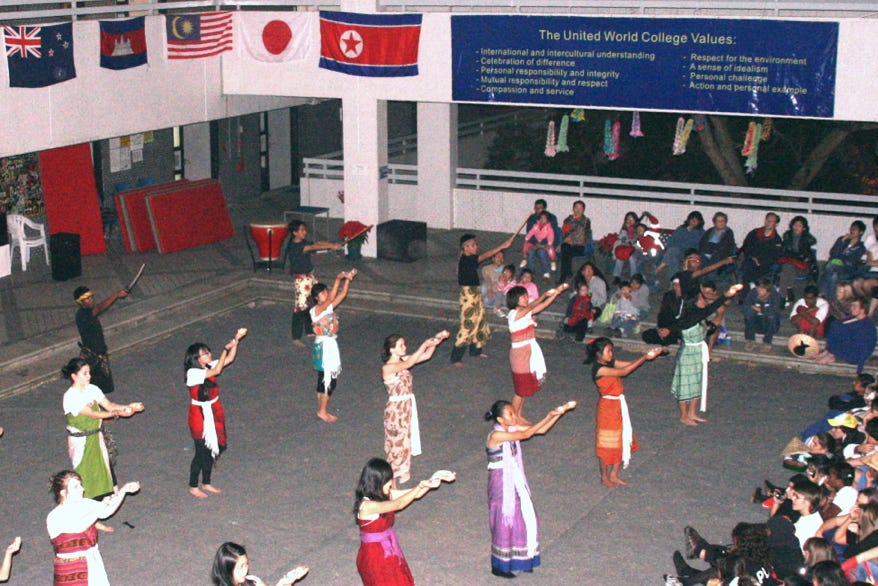 Cultural evening performance at Li Po Chun United World College of Hong Kong. The large banner overlooking the College’s central courtyard lists the College’s core values: (i) international and intercultural understanding; (ii) celebration of difference; (iii) personal responsibility and integrity; (iv) mutual responsibility and respect; (v) compassion and service; (vi) respect for the environment; (vii) a sense of idealism; (viii) personal challenge; and (ix) action and personal example.