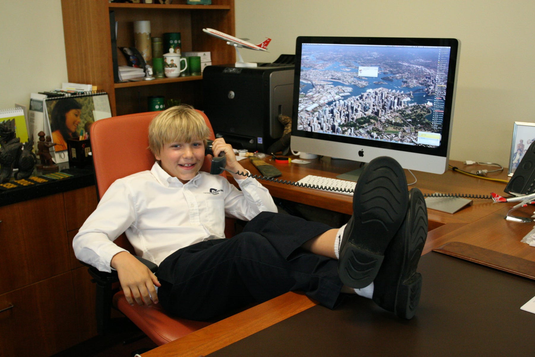 A student of The Awty International School in Houston, Texas, USA, 'plays' being Principal for a Day, and sits at the desk of the Principal, Dr Stephen Codrington.